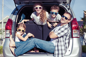 Image showing Happy family getting ready for road trip on a sunny day