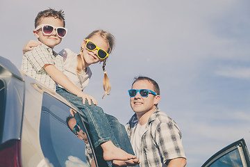 Image showing Happy family getting ready for road trip on a sunny day