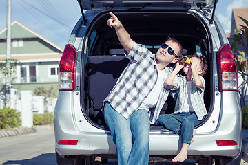 Image showing Happy father and son getting ready for road trip on a sunny day