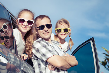 Image showing Happy family getting ready for road trip on a sunny day