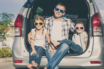 Image showing Happy family getting ready for road trip on a sunny day