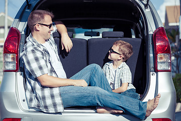 Image showing Happy father and son getting ready for road trip on a sunny day