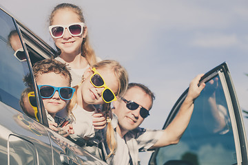 Image showing Happy family getting ready for road trip on a sunny day