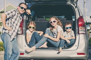 Image showing Happy family getting ready for road trip on a sunny day