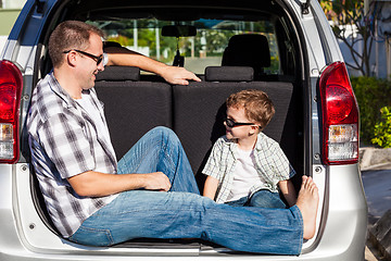 Image showing Happy father and son getting ready for road trip on a sunny day.