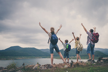 Image showing Happy family standing near the lake.