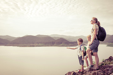 Image showing Happy family standing near the lake.