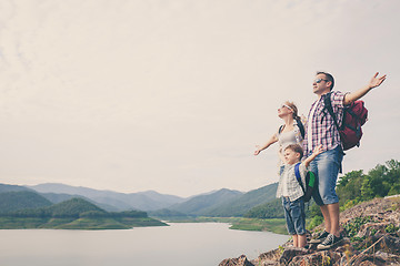 Image showing Happy family standing near the lake.