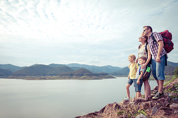 Image showing Happy family standing near the lake.