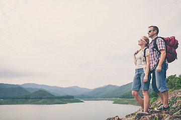 Image showing Happy family standing near the lake.