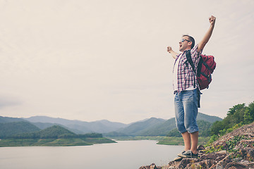 Image showing Happy man standing near the lake.