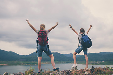 Image showing Mother and daughter standing near the lake.