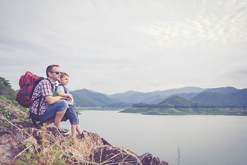 Image showing Father and son standing near the lake.