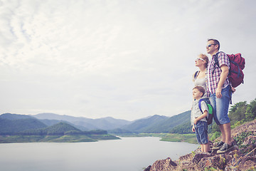 Image showing Happy family standing near the lake.