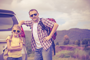 Image showing Father and daughter walking on the road.