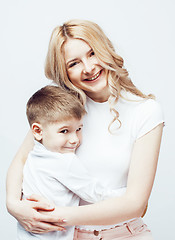 Image showing young modern blond curly mother with cute son together happy smiling family posing cheerful on white background, lifestyle people concept, sister and brother friends 