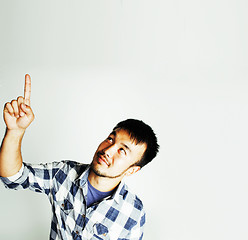 Image showing young cute asian man on white background gesturing emotional, po