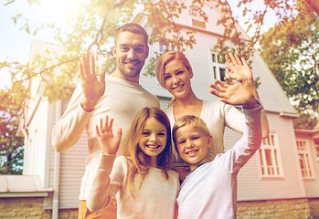 Image showing happy family in front of house outdoors