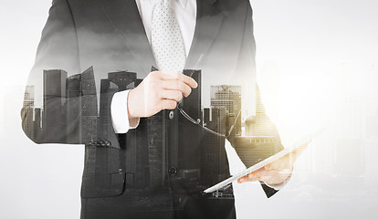 Image showing close up of businessman with tablet pc and glasses