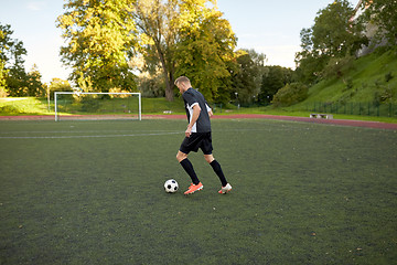 Image showing soccer player playing with ball on football field