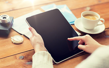 Image showing close up of traveler hands with tablet pc and map