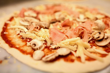 Image showing close up of pizza with cheese, ham and champignons