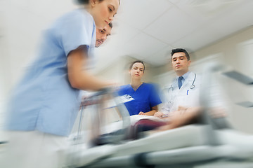 Image showing medics and patient on hospital gurney at emergency