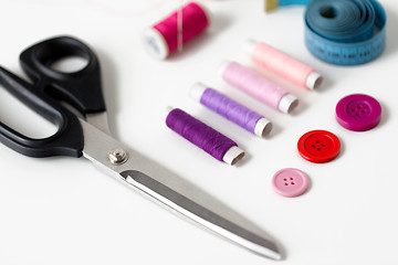 Image showing scissors, sewing buttons, threads and tape measure