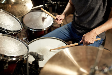 Image showing male musician playing drums and cymbals at concert