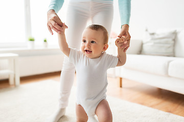 Image showing happy baby learning to walk with mother help