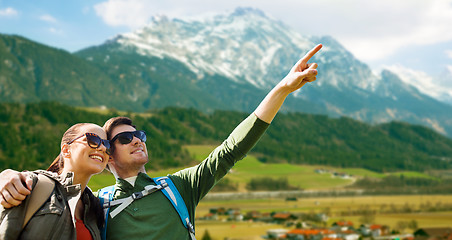 Image showing happy couple with backpacks traveling in highlands