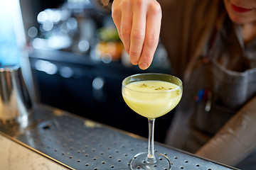 Image showing bartender with glass of cocktail at bar