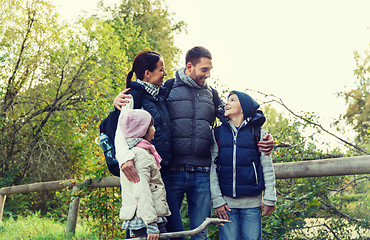 Image showing happy family with backpacks hiking