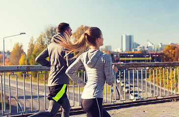 Image showing happy couple running outdoors