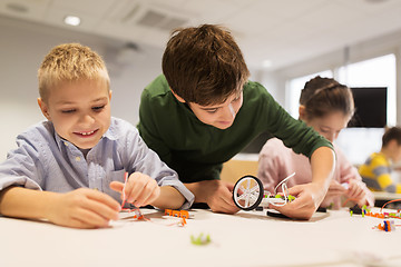 Image showing happy children building robots at robotics school