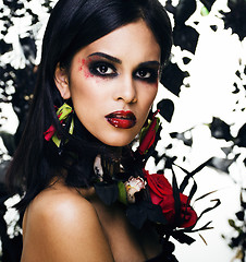 Image showing pretty brunette woman with rose jewelry, black and red, bright m