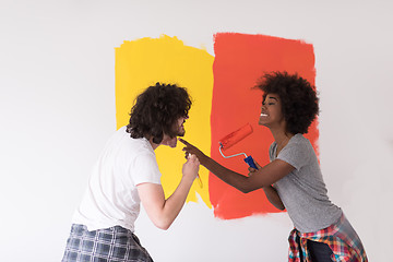 Image showing multiethnic couple painting interior wall