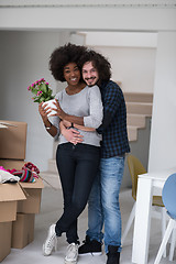 Image showing multiethnic couple moving into a new home