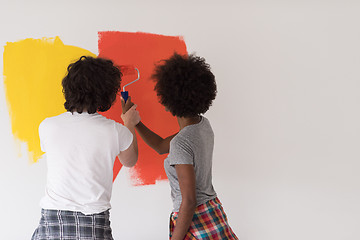 Image showing multiethnic couple painting interior wall