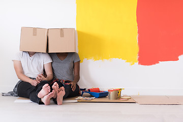 Image showing young multiethnic couple playing with cardboard boxes