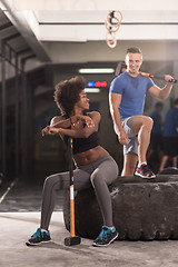 Image showing multiethnic couple after workout with hammer