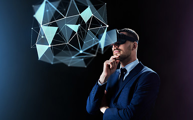 Image showing businessman in virtual reality headset over black