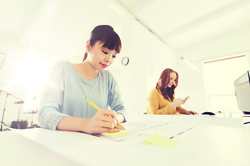 Image showing architect woman with blueprint writing at office