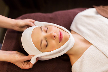 Image showing woman having face massage with towel at spa