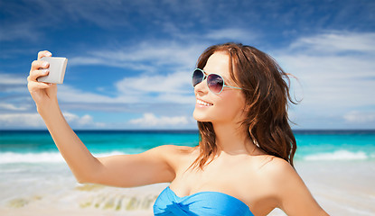 Image showing woman in swimsuit taking selfie with smatphone