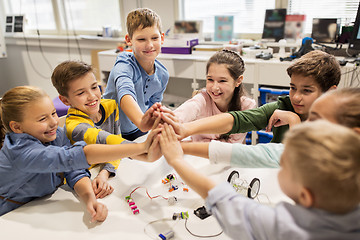 Image showing happy children making high five at robotics school