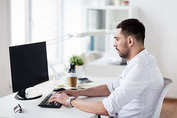 Image showing businessman typing on computer keyboard at office