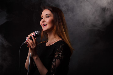 Image showing Singing woman background of smoke