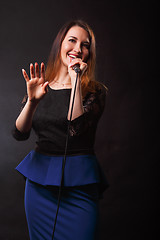 Image showing Long haired singer with microphone