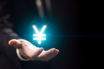 Image showing Businessperson hand holding yen symbol